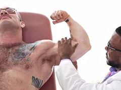Muscular hairy hunk gets fucked by black doctor after oil massage